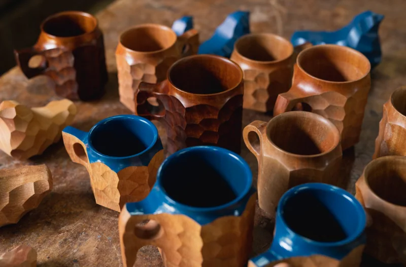 Blue and natural-wood JINCUPs on a table.